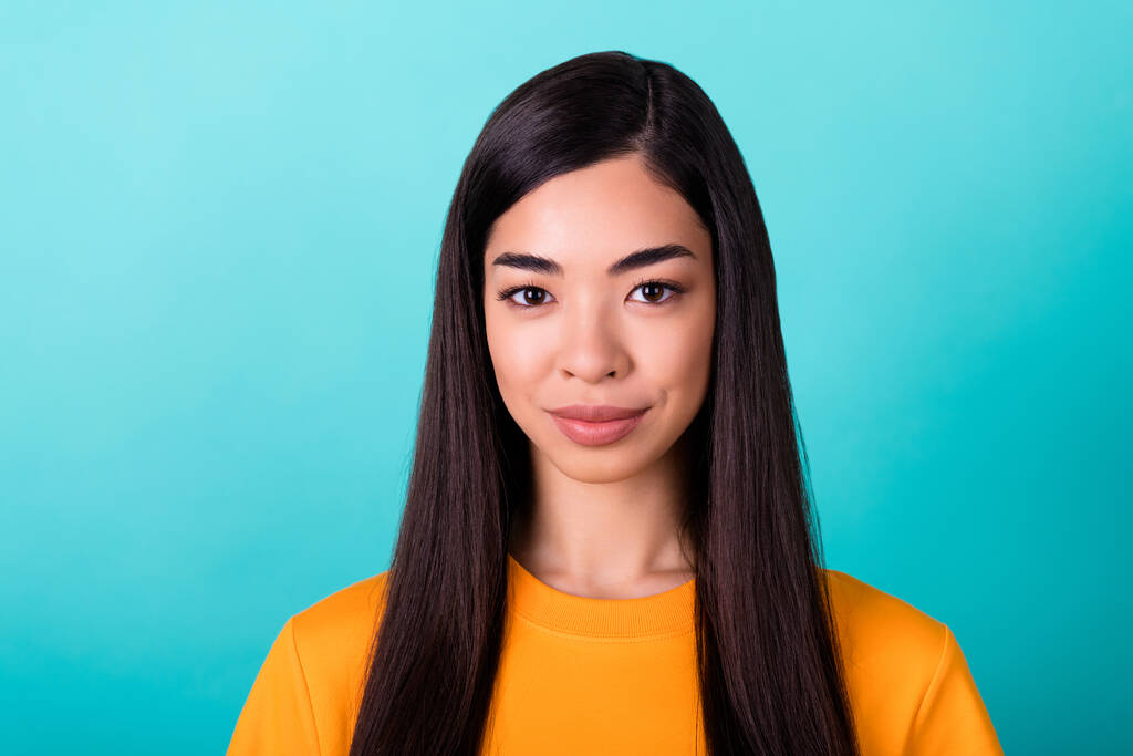Photo of pretty adorable gorgeous girl with straight hairdo wear yellow t-shirt looking at camera isolated on turquoise color background. - Fotó, kép