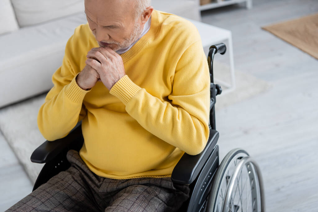 Sad elderly man sitting in wheelchair at home  - Foto, Bild
