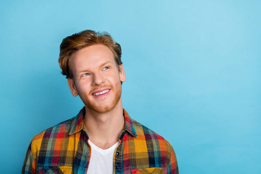 Closeup portrait of young guy wear plaid shirt interested looking empty space perspective bitcoin future isolated on bright blue color background. - 写真・画像