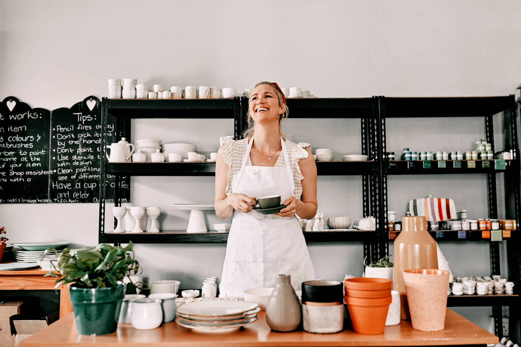 Я люблю свой выбор карьеры. привлекательная зрелая женщина, стоящая одна и держащая чашку кофе в своей мастерской - Фото, изображение