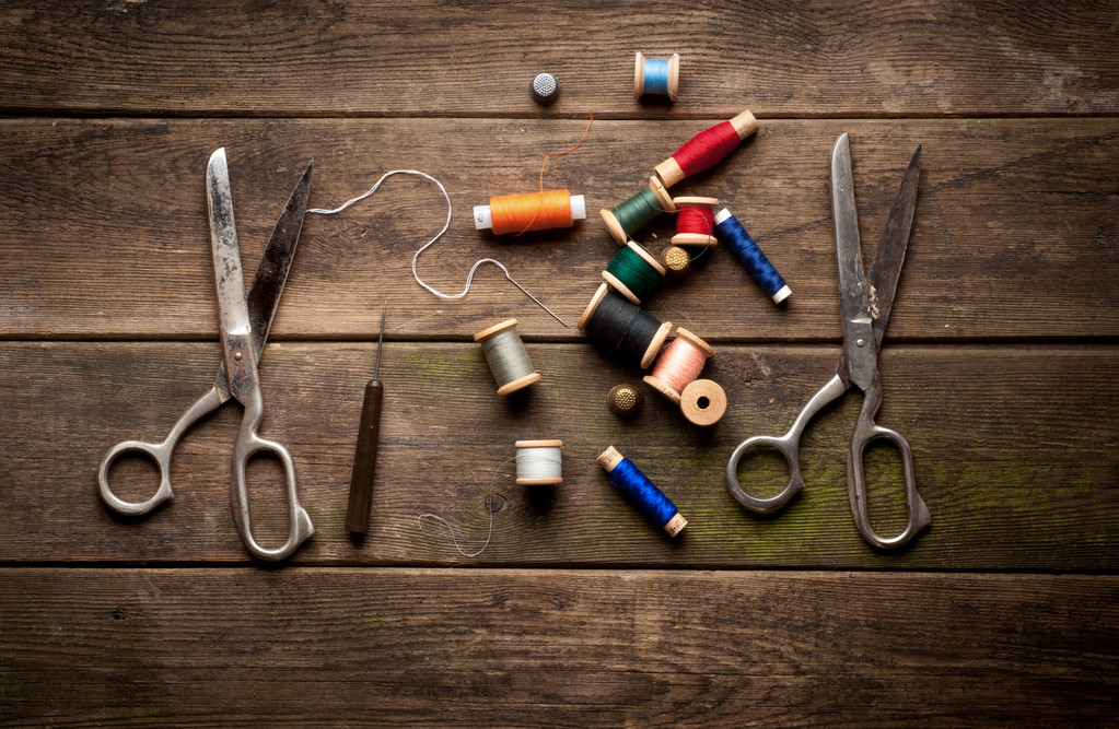 Fondo vintage con herramientas de costura y cinta de color. kit de costura. tijeras, bobinas con hilo y agujas en el fondo de madera antiguo - Foto, Imagen