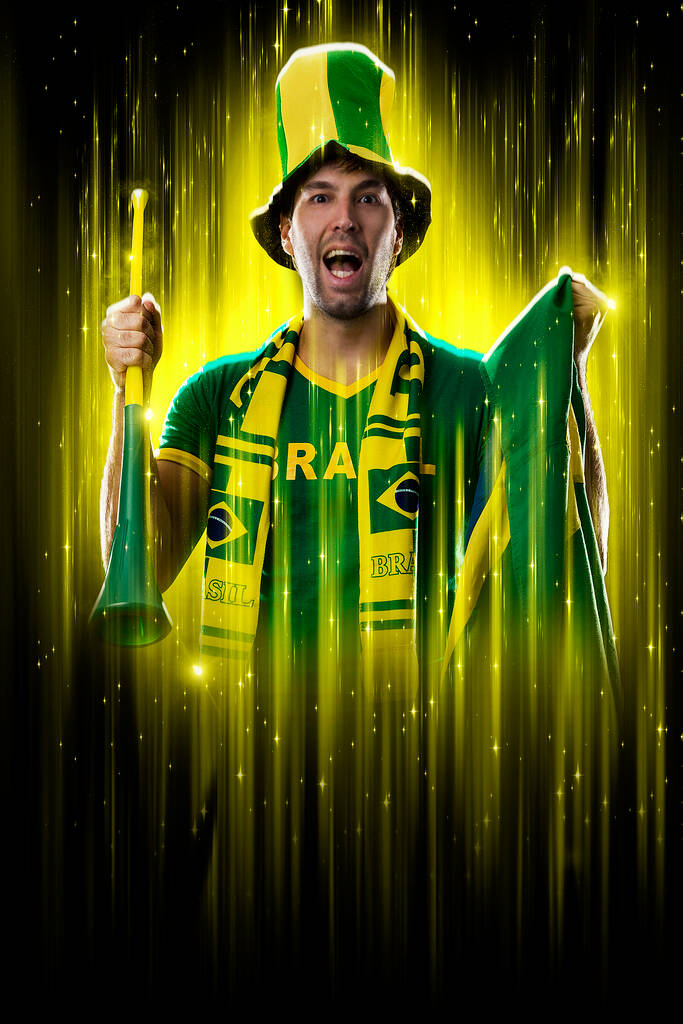 Brazilian fan, celebrating on a yellow and black backgroun, cheering for Brazil to be the champion. - Zdjęcie, obraz