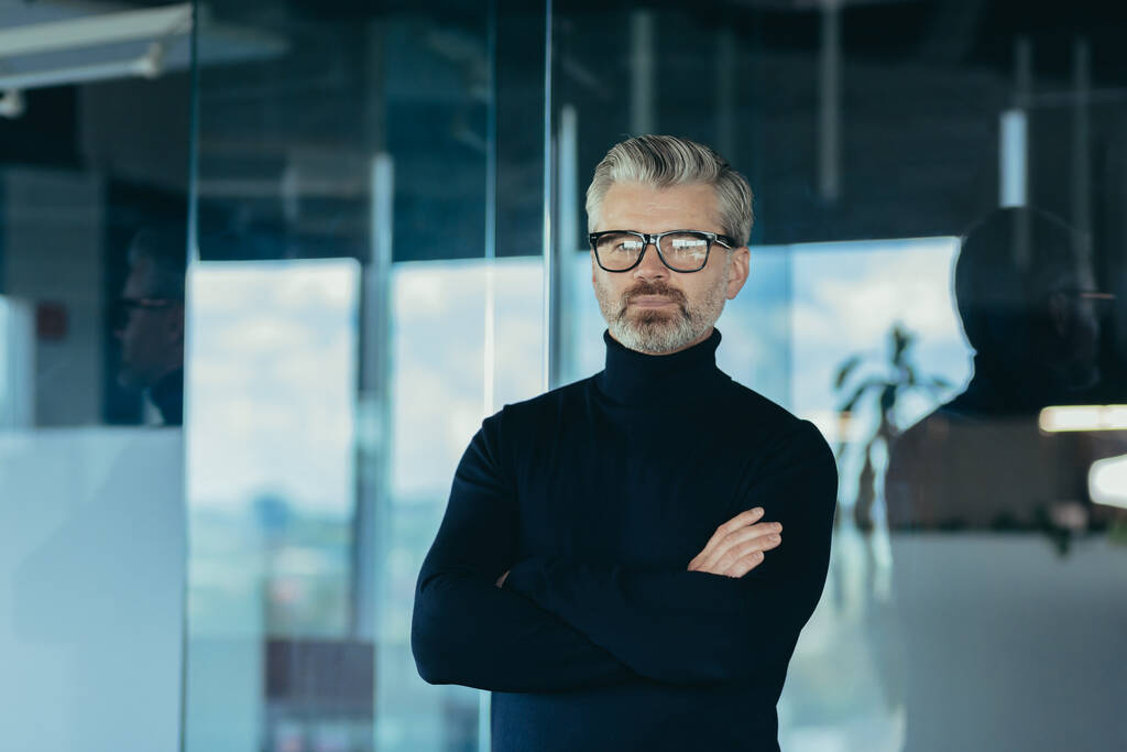 Portrait of serious and focused businessman with crossed arms, man working in office wearing glasses looking at camera, successful thoughtful investor - Zdjęcie, obraz