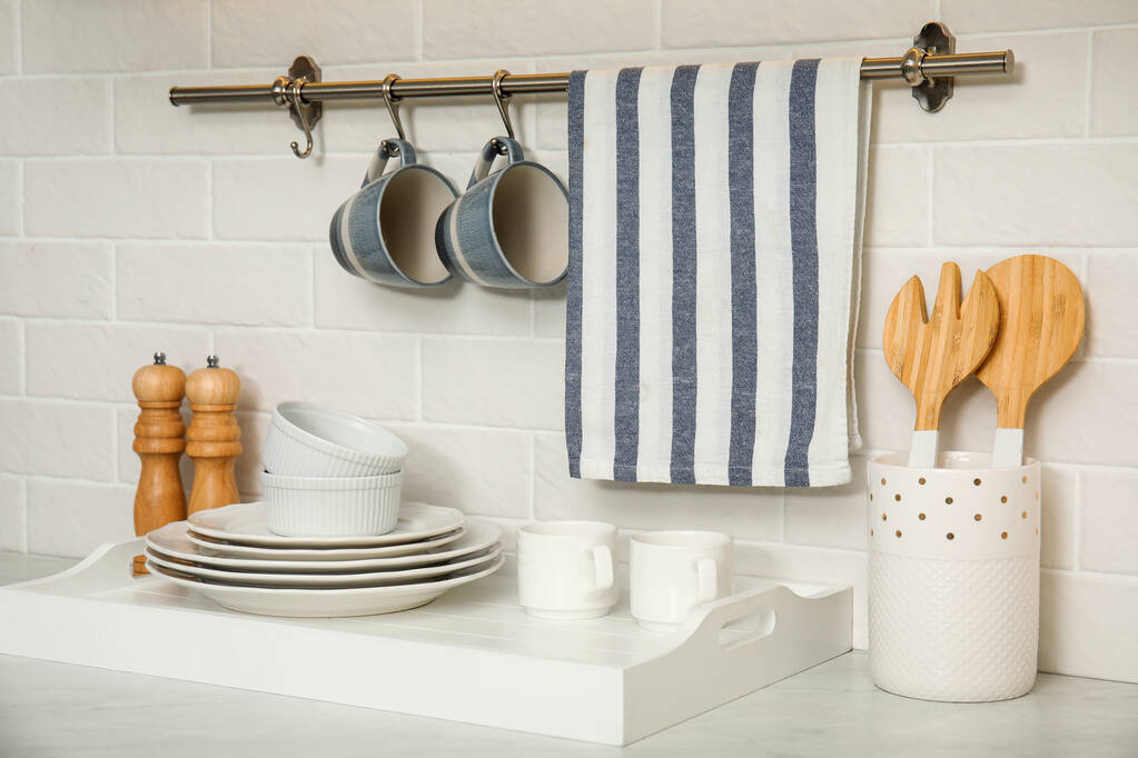 Clean towel, utensils and dishware in kitchen - Fotografie, Obrázek