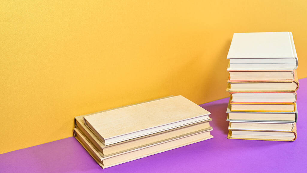 Golden purple background with hardcover books and copy space. Flat lay - Foto, Imagem