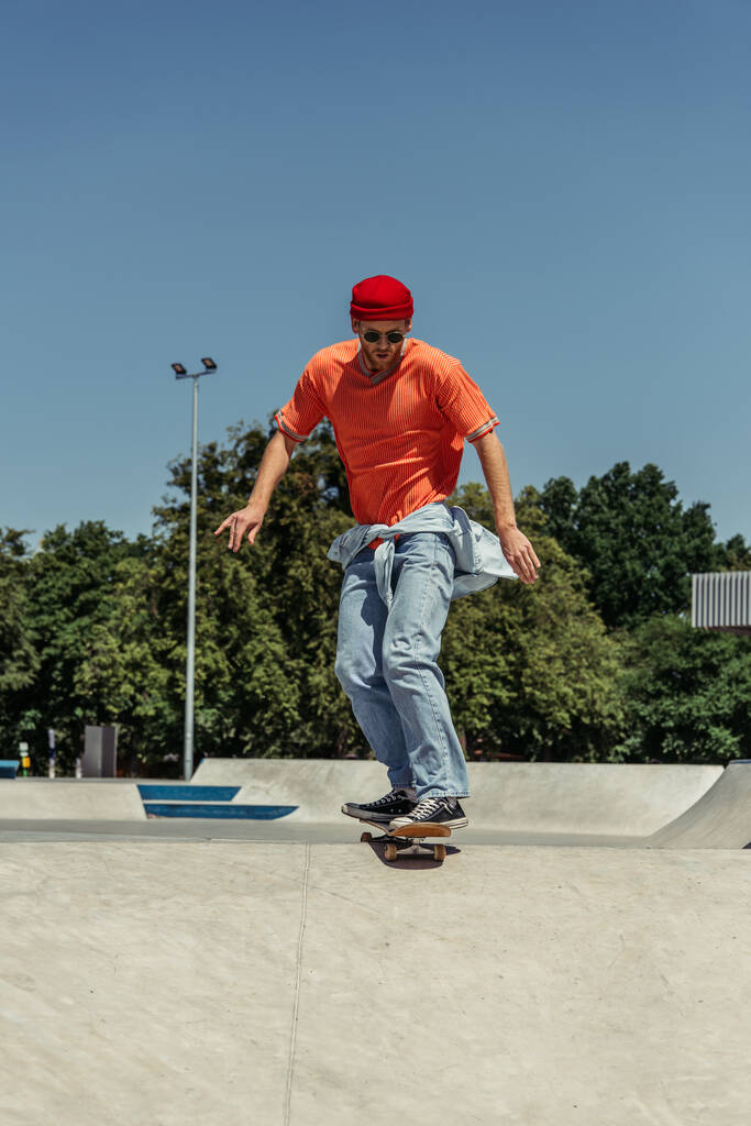 full length of man in trendy outfit training in skate park - Fotó, kép