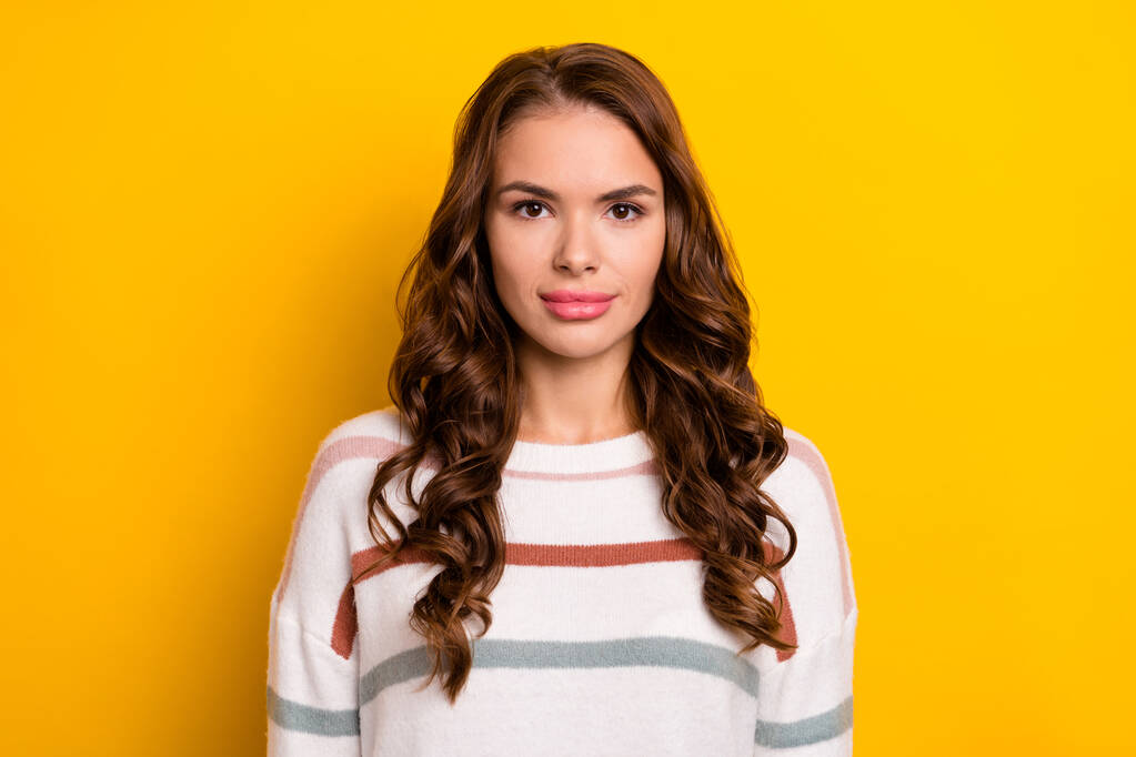 Closeup photo of young attractive pretty adorable lady wear striped sweater wavy hair isolated on yellow color background. - Photo, Image