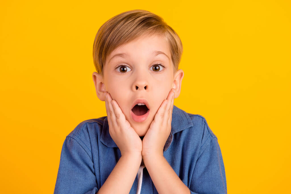 Photo of astonished excited boy arms touch cheekbones open mouth isolated on yellow color background. - Foto, imagen