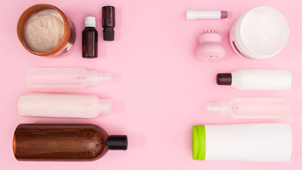 Creative layout of cosmetics products with copy space on pastel pink background. Flat lay - Fotoğraf, Görsel