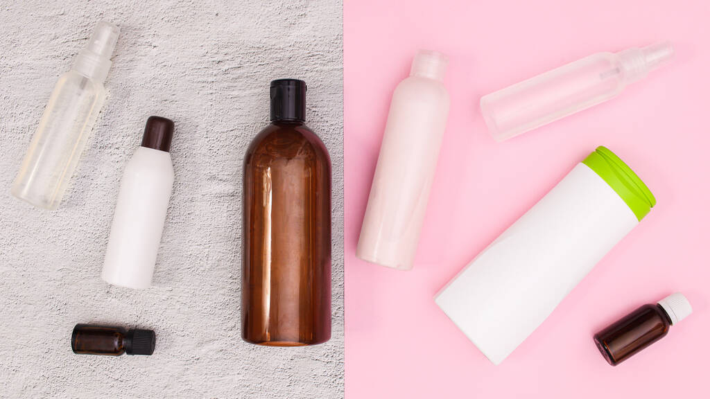 Bottles of Beauty and cosmetics products on white and pink background. Flat lay - Foto, imagen