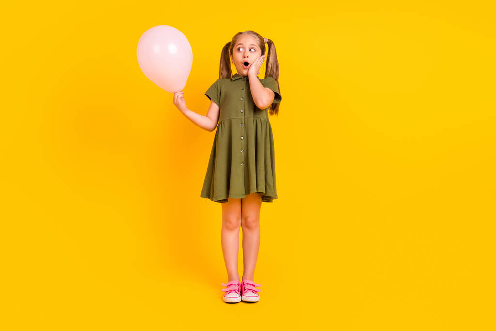 Full body portrait of shocked crazy person arm touch cheek open mouth look balloon isolated on yellow color background. - Valokuva, kuva