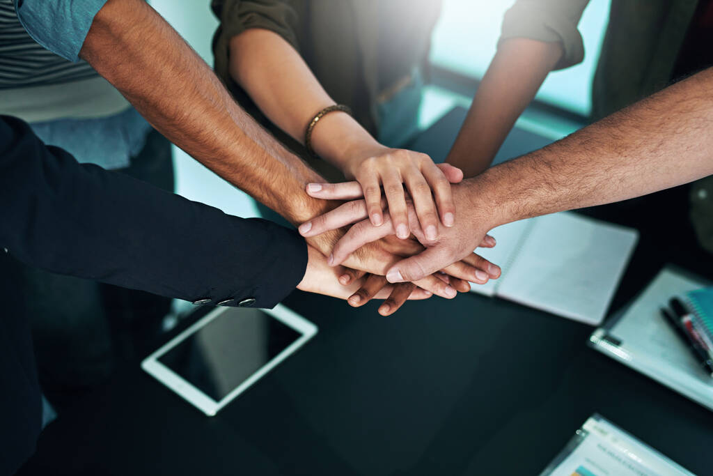Anything is possible if we work hard together. Closeup shot of a group of businesspeople joining their hands together in unity - Photo, Image