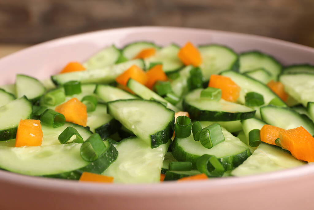 Tasty fresh salad with cucumber in bowl, closeup - Fotografie, Obrázek