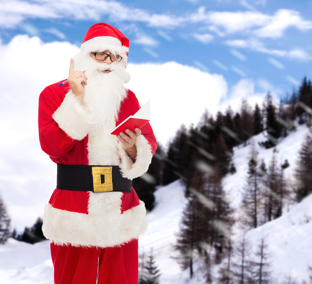 homme en costume de Père Noël claus avec bloc-notes
 - Photo, image