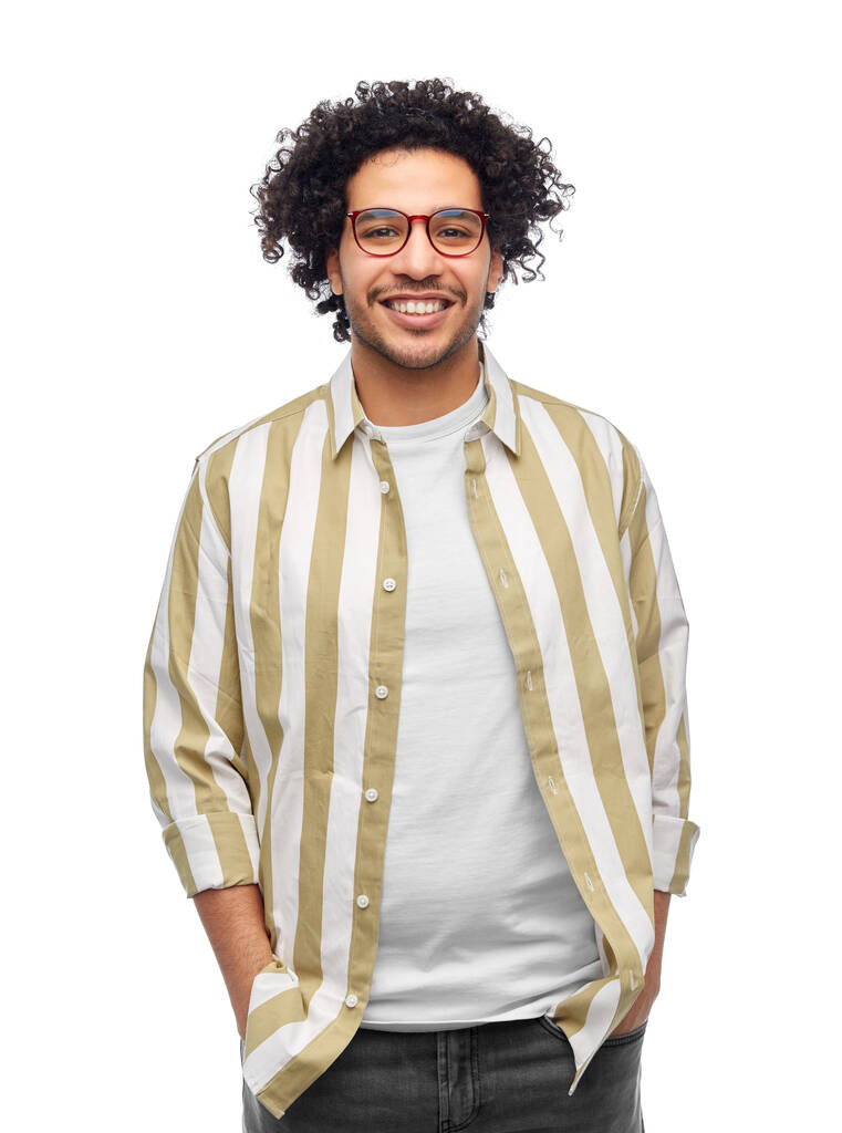 people and fashion concept - happy smiling man in glasses and striped shirt with hands in pockets over white background - Photo, image
