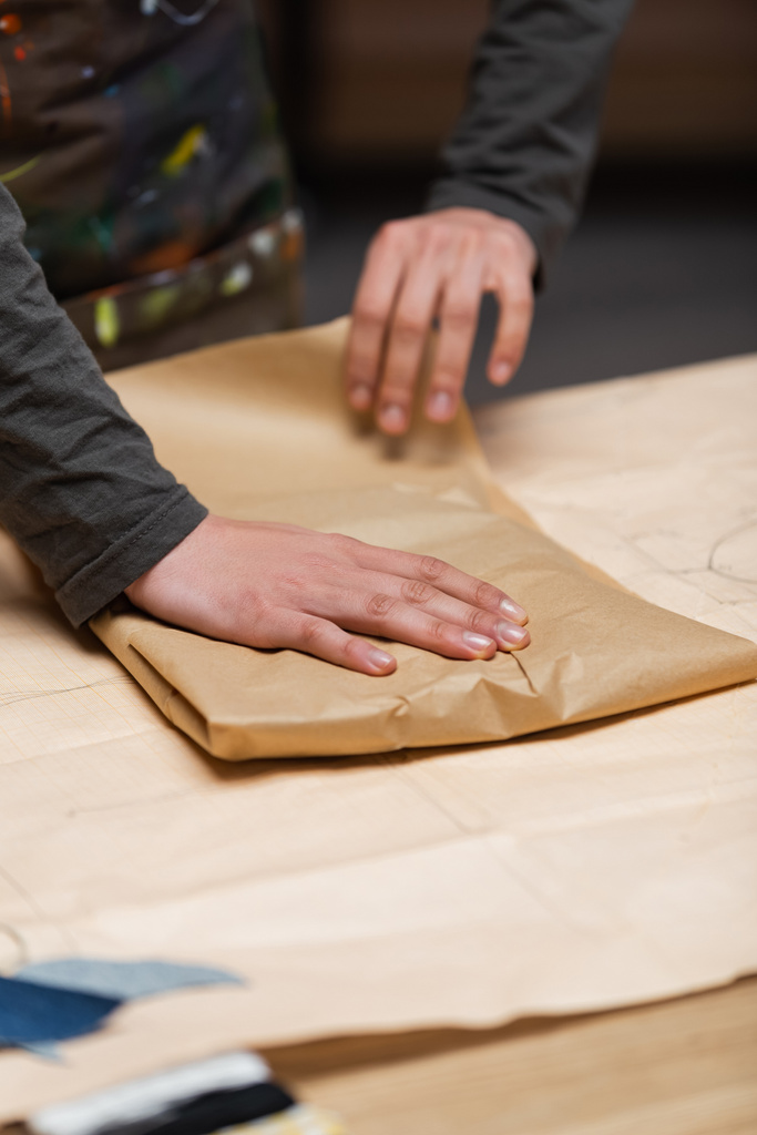 Обрезанный вид африканской американской дизайнерской упаковочной бумаги в мастерской  - Фото, изображение