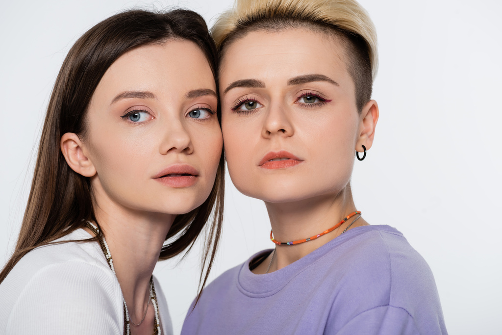 young and pretty lesbian couple with makeup isolated on grey - Foto, Bild