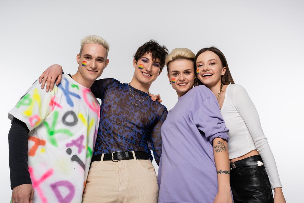 low angle view of lgbtq community friends smiling at camera isolated on grey - Foto, Imagem