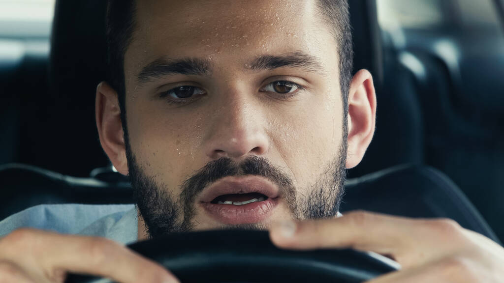 portrait of man with sweat on forehead driving car in hot summer day - Foto, Imagem