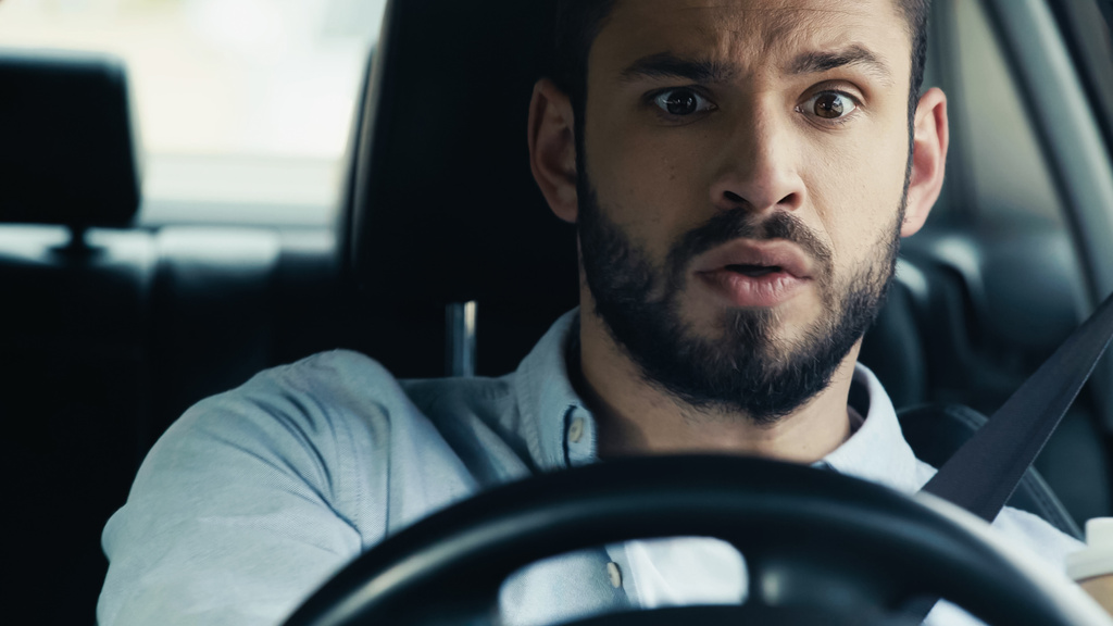 scared and worried man looking ahead while driving automobile - Foto, imagen