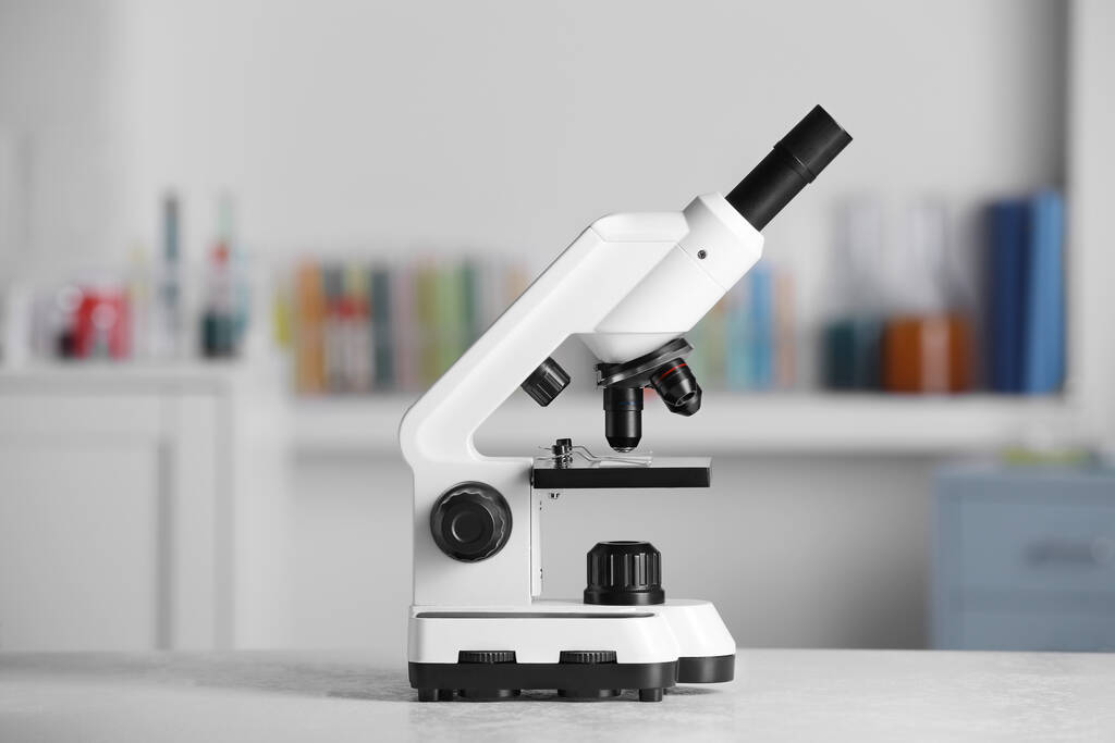 Modern medical microscope on white table in laboratory - Zdjęcie, obraz