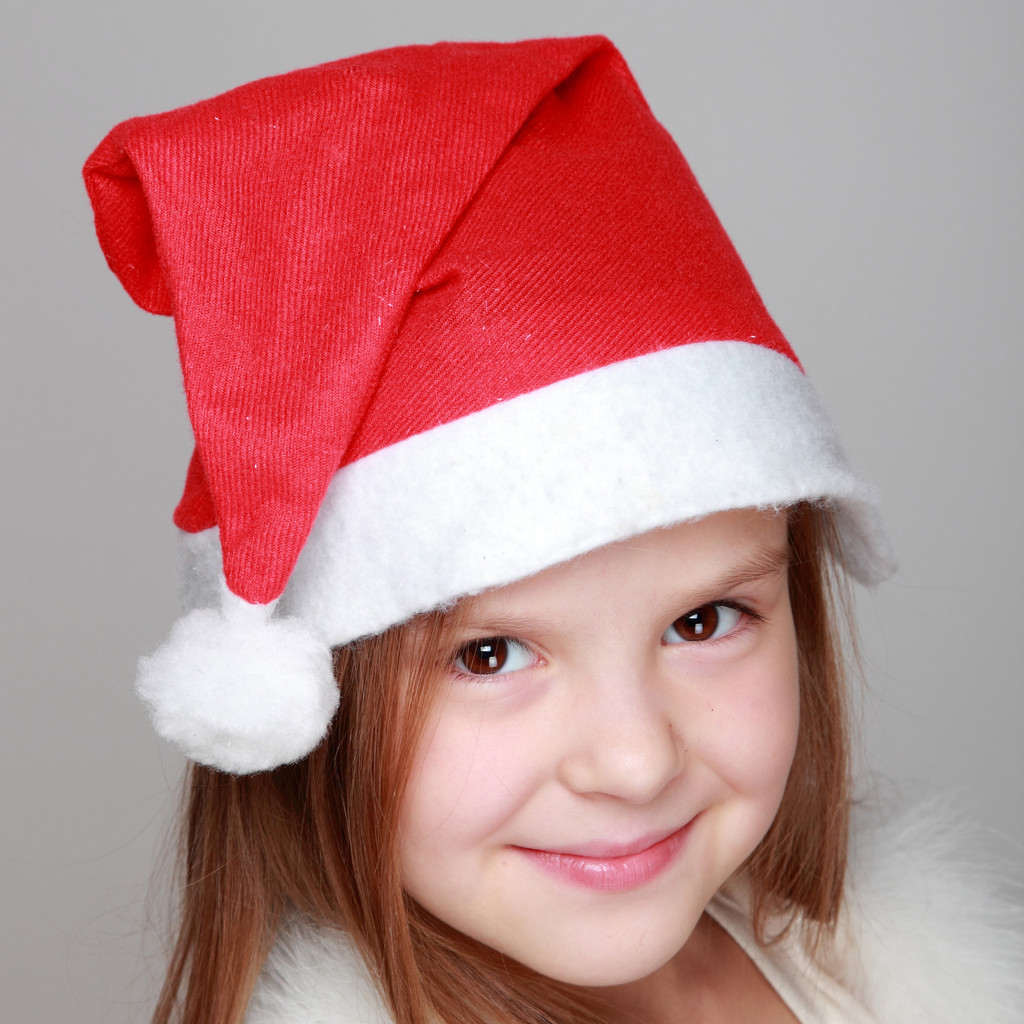 Porträt eines glücklichen kleinen Smiley-Mädchens mit Weihnachtsmütze - Foto, Bild
