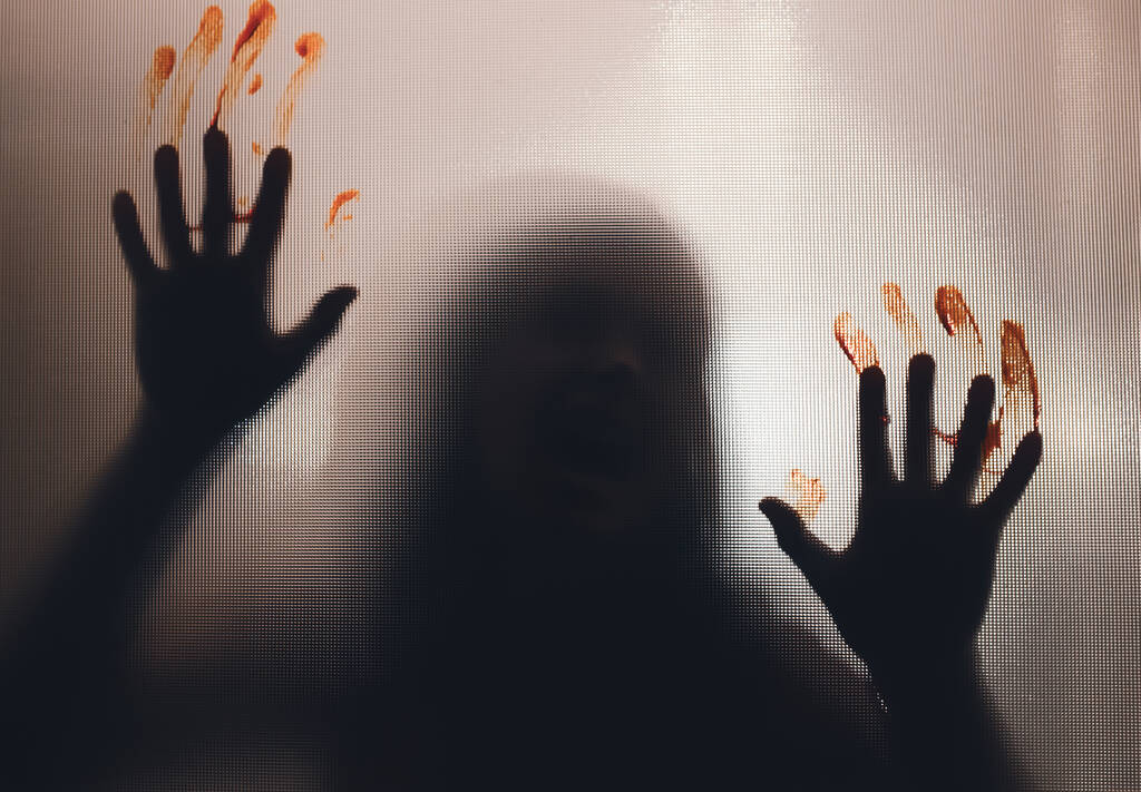 Horror ghost woman with blooded hands behind the matte glass. Halloween festival concept. - Valokuva, kuva