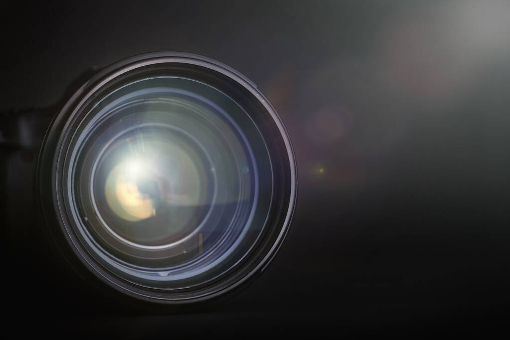Modern camera lens on black background, closeup. Space for text - Photo, Image