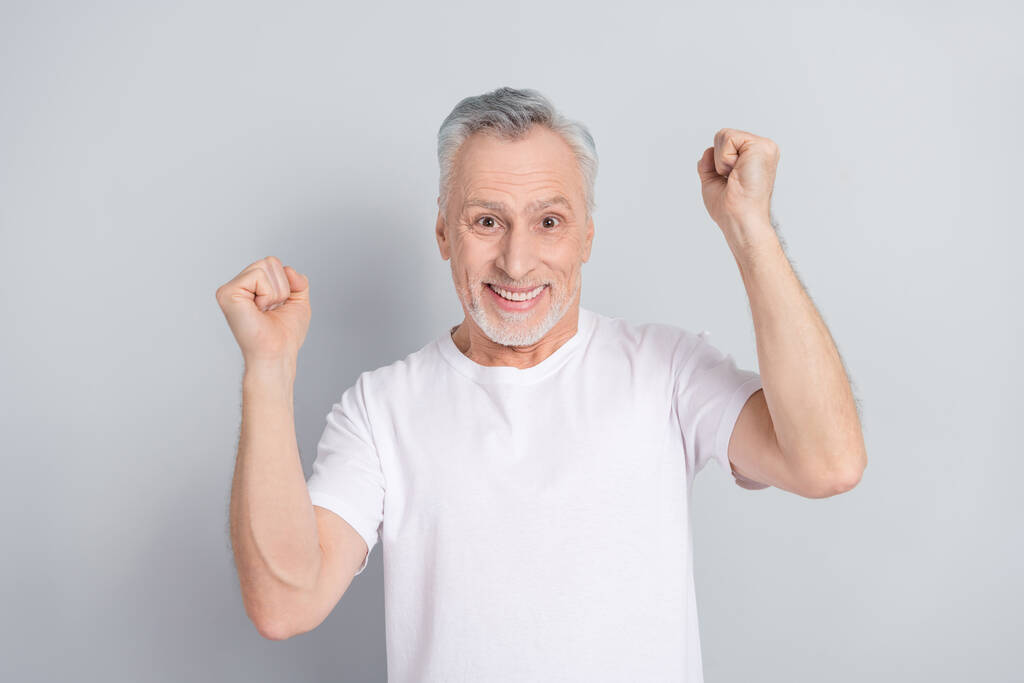Photo of hooray aged man yell wear white t-shirt isolated on grey color background. - Photo, Image