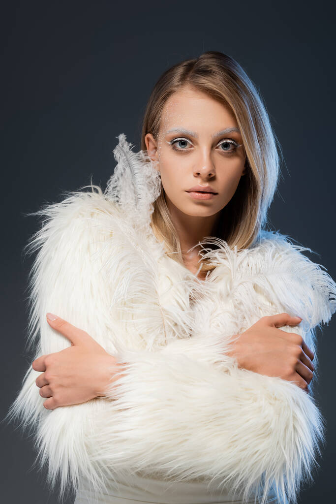 blonde young woman with white makeup posing with crossed arms isolated on blue - Photo, Image