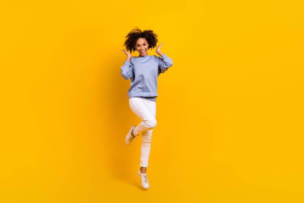 Full size portrait of overjoyed pretty lady jumping hands touch wavy hairdo isolated on yellow color background. - Photo, Image