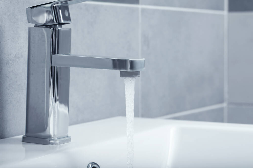 Stream of water flowing from tap in bathroom - Photo, Image
