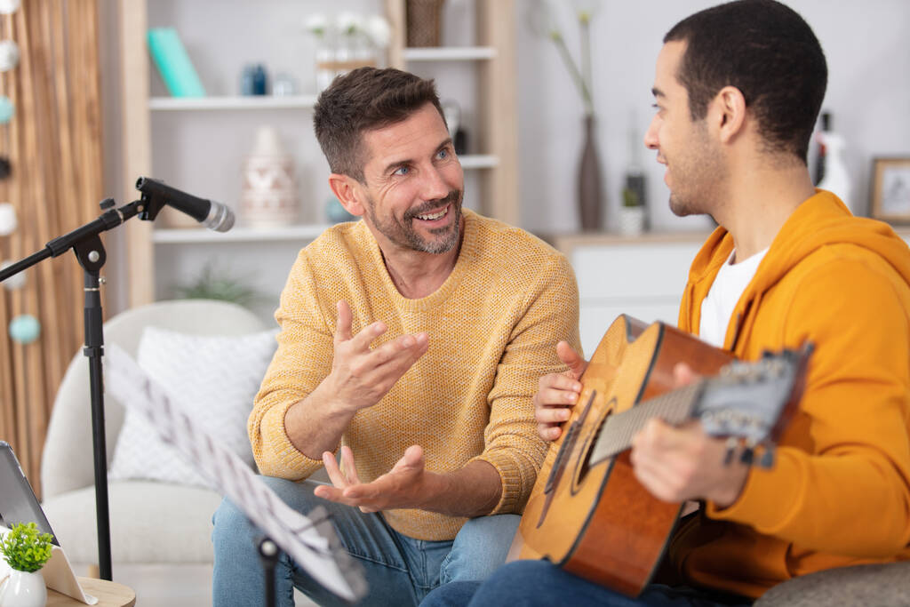 young loving gay couple relaxing with a guitar - Photo, Image