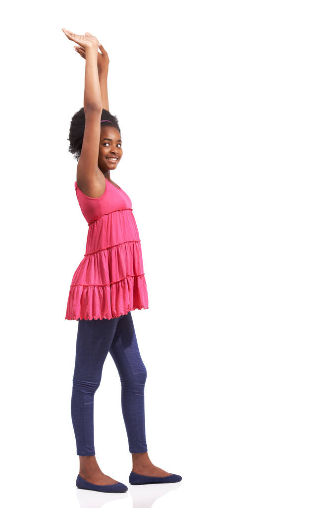 I want to be this tall when I grow up. Full length studio portrait of a young african american girl standing with her arms raised isolated on white - Photo, Image