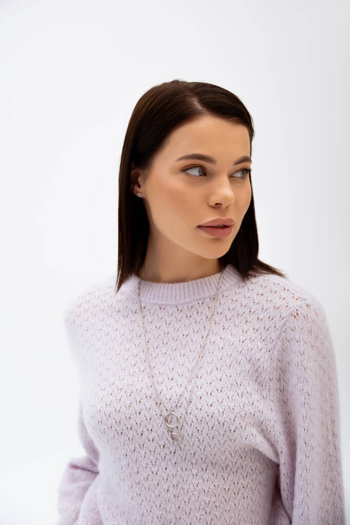 Young woman in warm sweater looking away isolated on grey  - Photo, Image