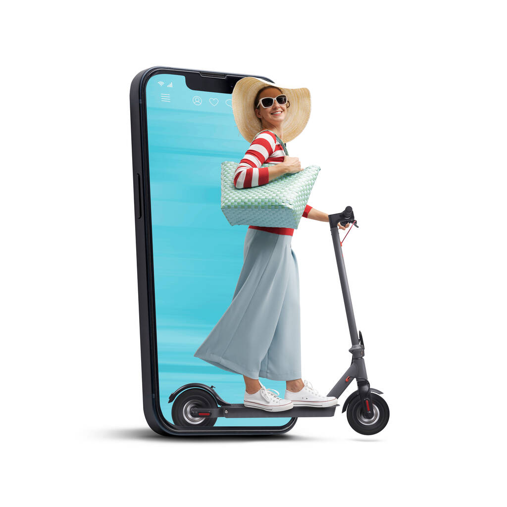 Happy fashionable woman riding an eco-friendly electric scooter, she is coming out from a smartphone screen, smart mobility concept - Photo, Image