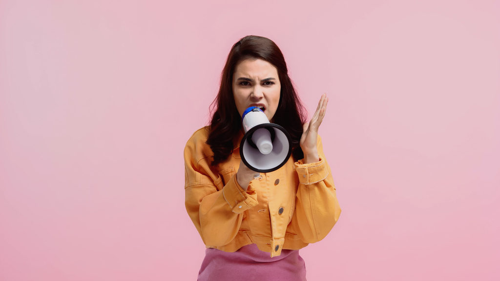irritated woman making announcement in megaphone isolated on pink - Photo, Image