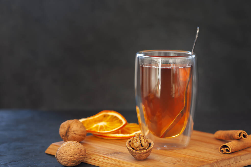 Filiżanka świeżej aromatycznej herbaty z przyprawami z anyżu gwiazdkowego, paluszkami cynamonu i suszonymi pomarańczami - Zdjęcie, obraz