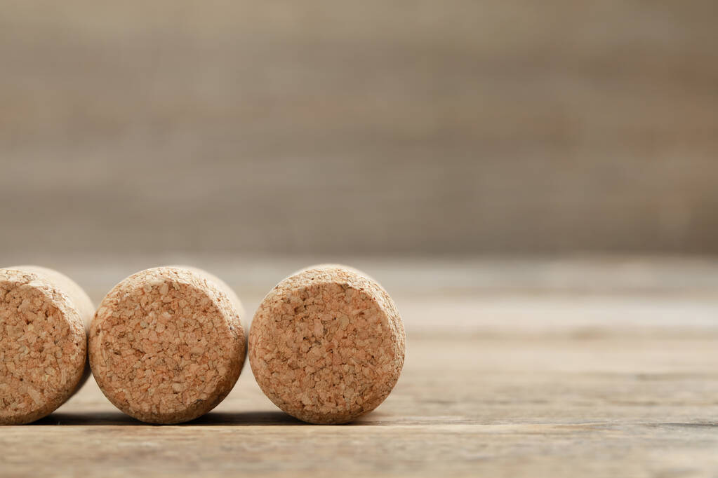 Corks of wine bottles on wooden table, closeup. Space for text - Photo, Image