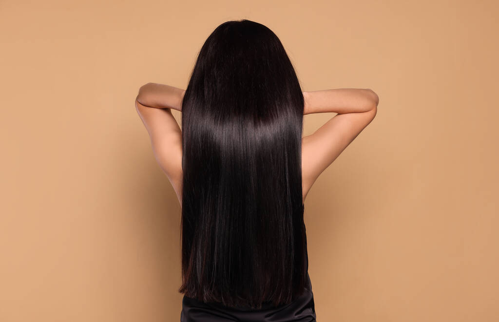 Nő erős egészséges haj bézs háttér, vissza nézet - Fotó, kép