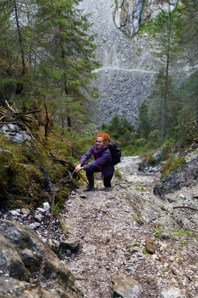 Kobieta z plecakiem na szlaku turystycznym w górach - Zdjęcie, obraz