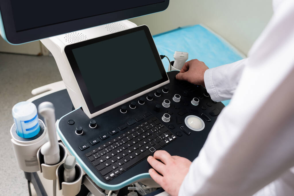 high angle view of modern ultrasound machine near cropped doctor - Photo, Image