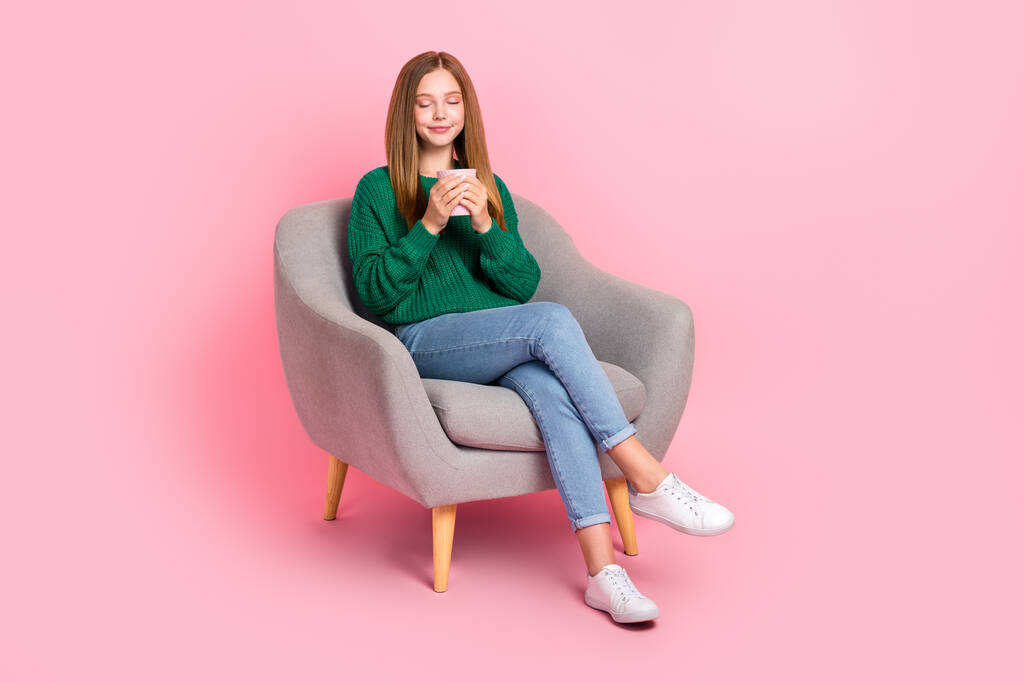 Full length photo of sweet dreamy young lady wear green sweater enjoying tasty beverage empty space isolated pink color background. - Photo, Image