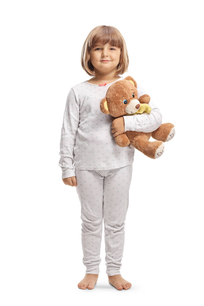 Retrato de comprimento total de uma menina de pijama segurando um urso de pelúcia isolado no fundo branco - Foto, Imagem