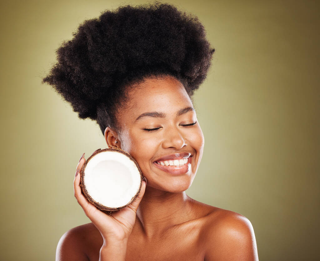 Beauty, skincare and smile with black woman and coconut for moistuize, rejuvenation or tropical. Antioxidants, natural and vitamins with luxury girl model for nutrition, diet or organic treatment. - Photo, Image