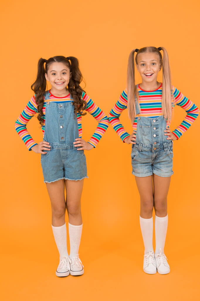 Vibrant colors. Modern fashion. Kids fashion. Girls long hair. Cute children same outfits. Little girls wearing rainbow clothes. Matching outfits. Trendy and fancy. Fashion shop. Must have accessory. - Photo, Image