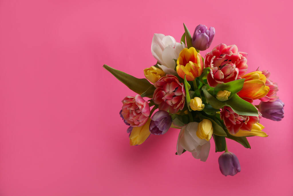Bouquet of beautiful tulips on pink background, top view. Space for text - Photo, Image