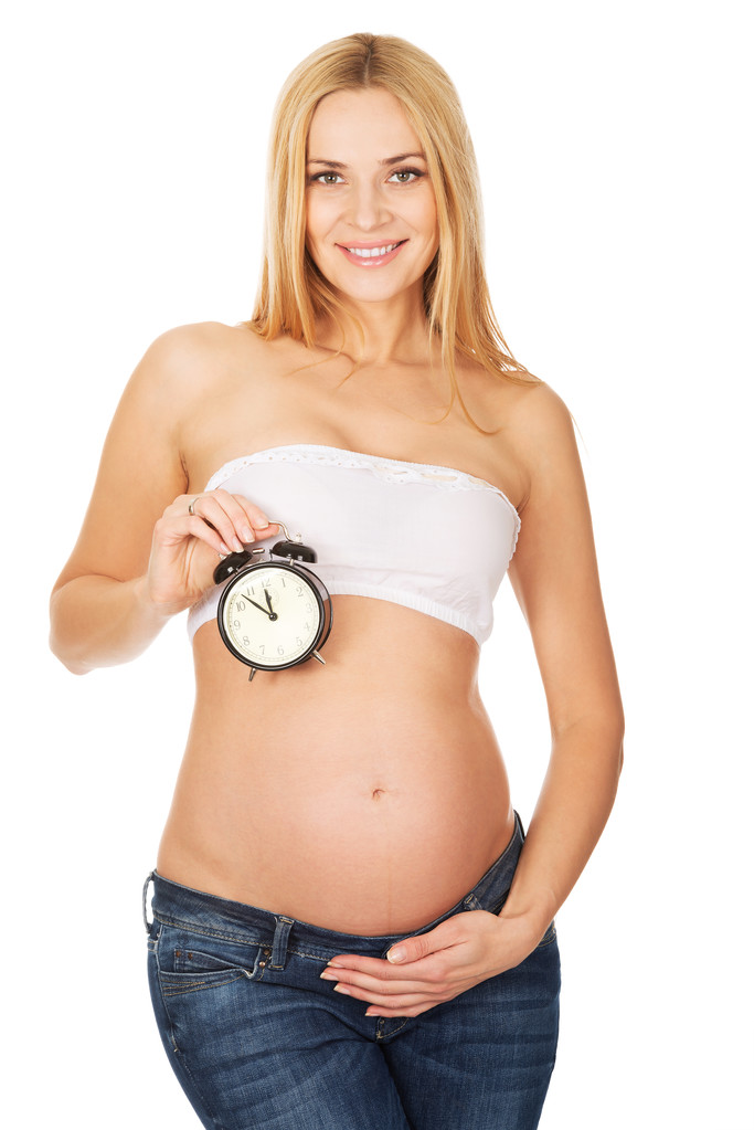 Donna incinta con una sveglia
 - Foto, immagini