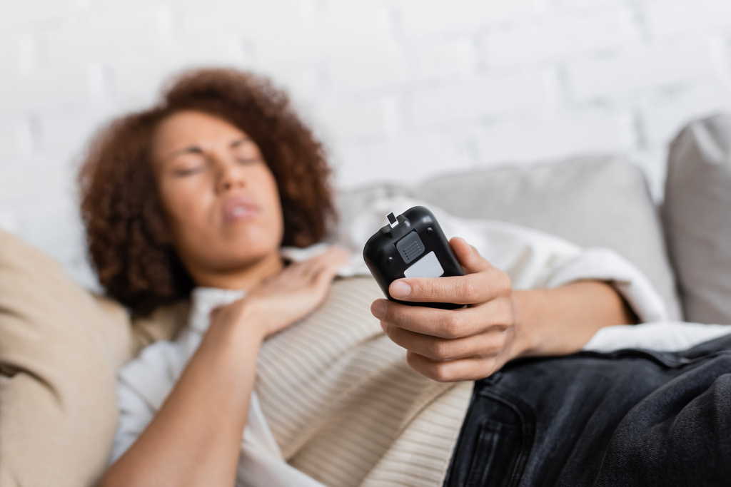 Afrikai-amerikai nő cukorbetegség rossz közérzet és tartja glucometer otthon  - Fotó, kép