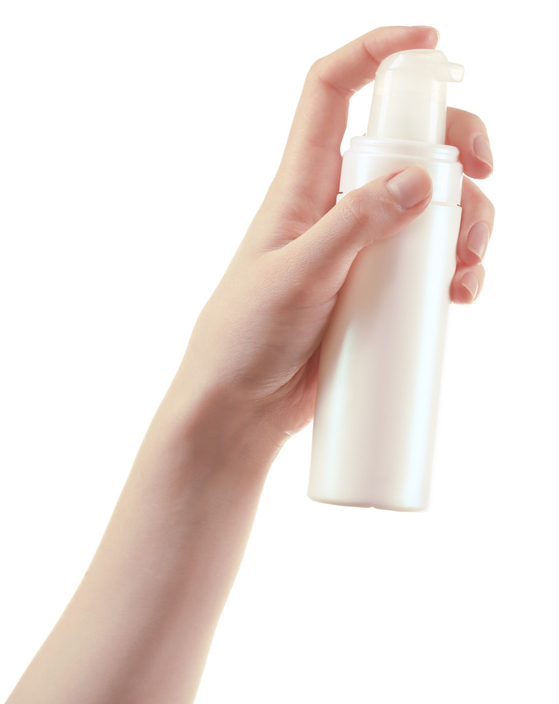 Female hand with cosmetics bottle isolated on white - Photo, Image